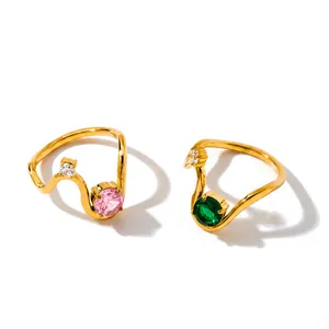 Close-up of elegant gold geometric stainless steel rings with pink and green zircons