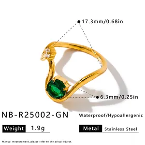 Detail of a gold stainless steel geometric ring with a sparkling green zircon stone inlay