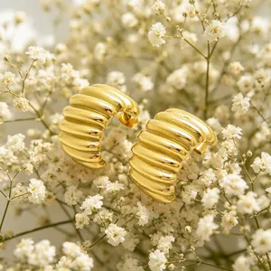 Macro close-up detail of 18K gold plated ribbed stainless steel chunky hoop earrings