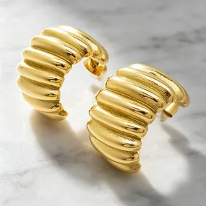 Close-up of 18K gold plated stainless steel hoop earrings with unique pleated texture