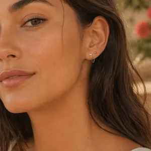 Detailed close-up of 18k gold-plated stainless steel chain earrings with zircon on a model