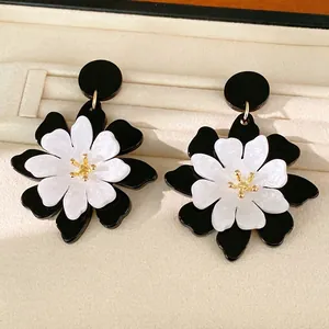 French vintage style black and white acrylic flower stud earrings with gold accents