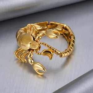 Detailed macro view of a bold gold-plated titanium steel scorpion bracelet showing exquisite carving