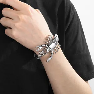 Detailed close-up of a bold silver titanium steel scorpion bracelet on a male wrist