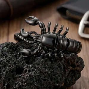 Detailed close-up of a masculine black scorpion-shaped titanium steel bracelet on rock
