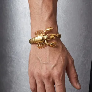 Detailed view of a gold scorpion titanium steel bracelet on a male wrist
