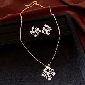 Elegant gold-tone zircon sunburst pendant necklace and stud earrings jewelry set for women