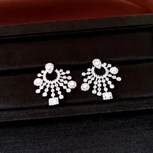 Detailed macro view of elegant silver-toned chandelier earrings set with cubic zirconia stones.