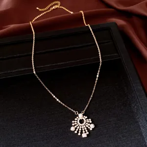 Close-up view of elegant zircon circular sunburst pendant necklace on jewelry tray