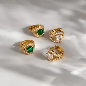 Close-up of luxury stainless steel snake hoop earrings with green and clear zirconia stones