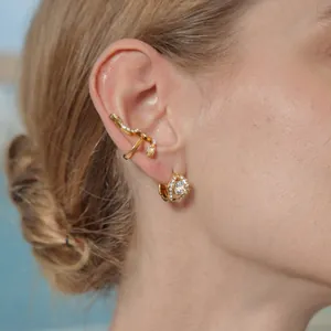 Detailed view of gold stainless steel snake ear cuff and zircon hoop earring set