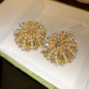 Macro detail of stunning French vintage gold flower earrings with pearls and diamonds