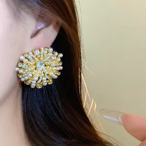 Macro detail view of elegant French vintage flower stud earring with pearls and rhinestones