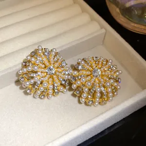 Detailed view of vintage-style floral stud earrings with pearls and rhinestones