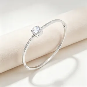 Detail view of a silver titanium steel bangle with square rhinestone center piece