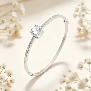 Macro view of an elegant silver titanium steel bangle with a square halo crystal setting