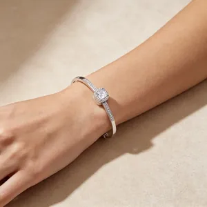 Detail view of an elegant titanium steel square halo rhinestone bracelet on wrist.