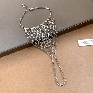 Close-up view of an elegant silver hollow mesh finger bracelet harness jewelry item