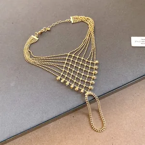 Intricate gold mesh slave bracelet with delicate bead accents and layered chain design