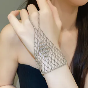 Detailed close-up of elegant silver beaded mesh finger bracelet on a model's hand