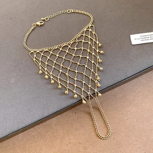 Close-up of gold hollow tassel ring bracelet integrated hand chain with mesh design