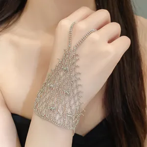Close-up of elegant silver hollow tassel hand chain bracelet and ring combo for women