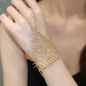 Elegant gold hollow-out mesh hand harness with delicate fringe tassel detail on model