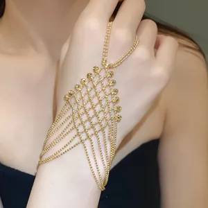 Elegant gold-colored mesh tassel hand chain slave bracelet detail shown on model's hand