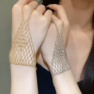 Close-up detail of hollow-out mesh ring bracelet integrated chains in gold and silver
