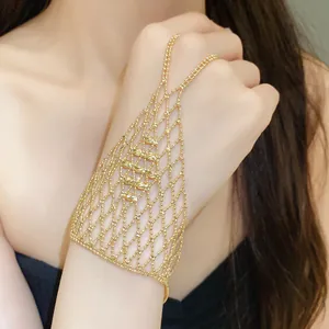 Detailed shot of gold hollow mesh ring-bracelet combo with elegant tassel design