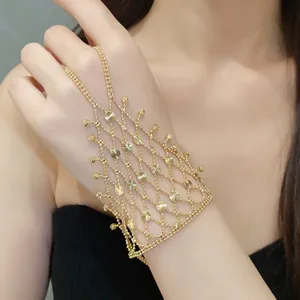 Elegant gold-tone hollow tassel ring bracelet hand chain with intricate design on model