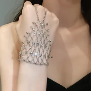 Close-up of intricate silver hollow mesh hand chain worn on model's hand