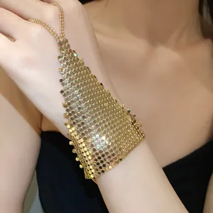 Close-up detail of a luxurious gold sequin mesh ring bracelet and hand chain accessory
