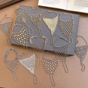 Detail of various gold and silver mesh hand harness ring bracelets with tassels