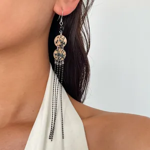 Gros plan de boucles d'oreilles vintage en acrylique avec imprimé bambou et chaînes