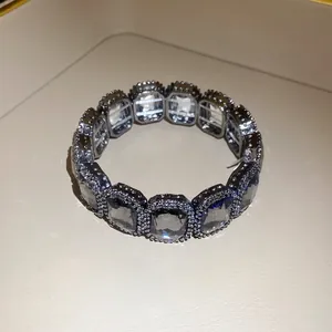 Macro detail of a vintage elastic bracelet with large clear crystals and pavé beads