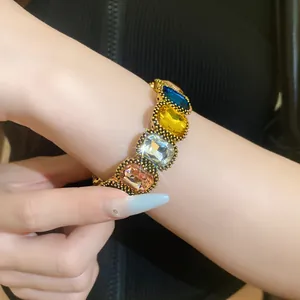 Detailed view of a vintage style elastic bracelet with large colorful oval crystals