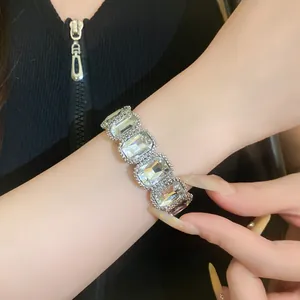 Close-up detail of a vintage-style stretchy bracelet with large rectangular clear crystals.