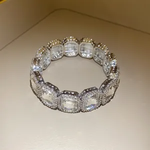 Close-up of a vintage style elastic bracelet with square-cut sparkling rhinestones.