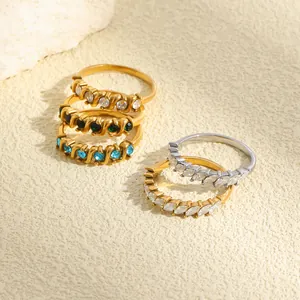 Detailed view of stacked stainless steel rings with marquise and round crystals