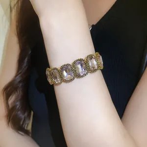 Elegant vintage style stretch bracelet with large faceted clear crystals on arm
