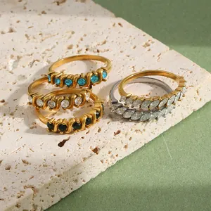 Detail view of 18K gold plated stainless steel rings with round and marquise stones