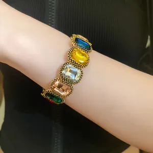 Close-up of vintage gold-toned bracelet with vibrant multi-colored oval gemstones