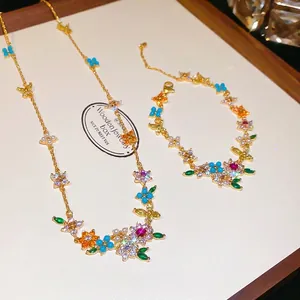 Elegant 18k gold plated jewelry set featuring flower necklace and bracelet with colorful zircon