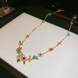 Detailed view of an 18k gold plated necklace featuring colorful floral zircon accents