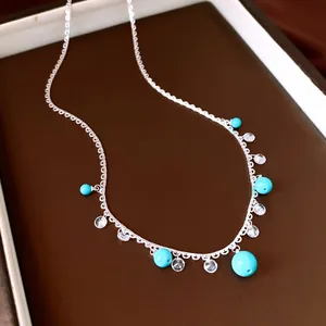 Detailed view of elegant silver lace necklace featuring turquoise beads and zircon charms