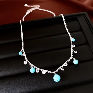 Detailed view of silver lace pendant necklace featuring blue stone beads and sparkling zircons