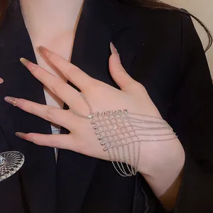 Detail of silver mesh hand harness ring bracelet with intricate bead fringe on hand