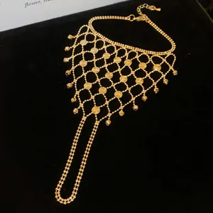Detailed view of hollow gold mesh tassel integrated ring bracelet with sparkling sequins.