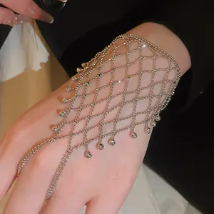 Detailed view of elegant silver beaded mesh hand chain with tassel ring integration